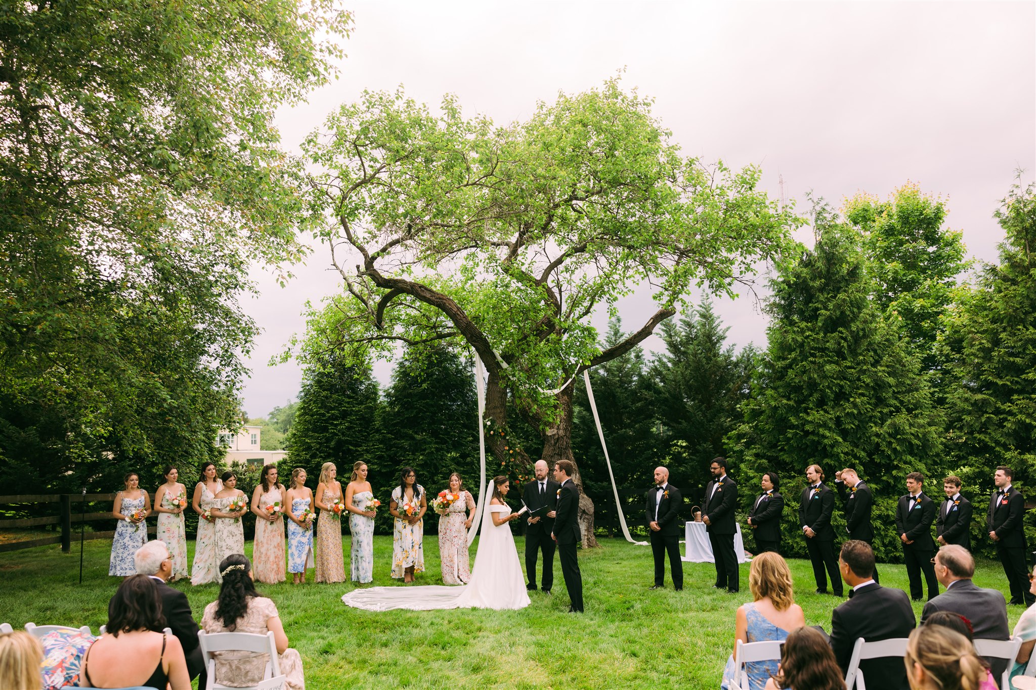 bride and groom getting married under a tree