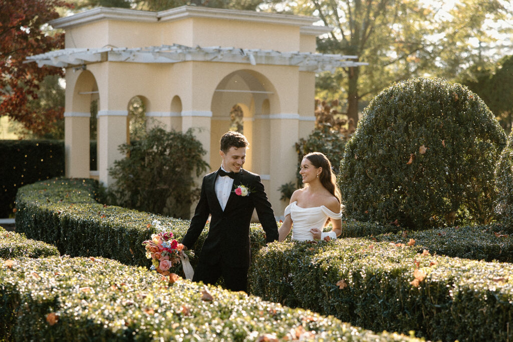 couple walking through the gardens at the Airlie hotel